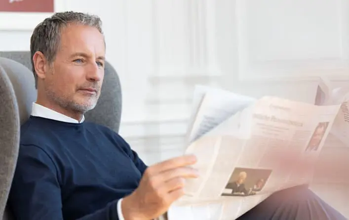 Männlicher Leser mit Zeitung