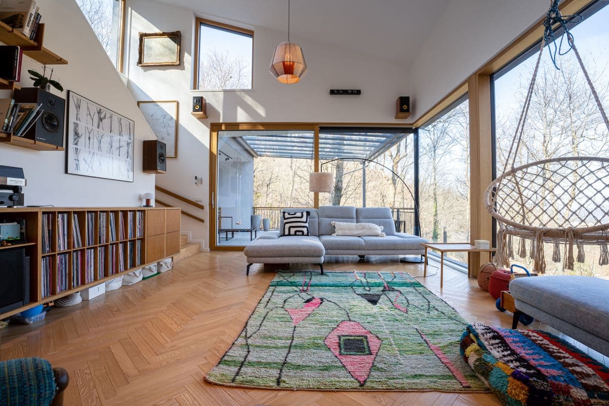 Großzügiges Neubau-Wohnzimmer mit bodentiefen Fenstern und Boho-Einrichtung